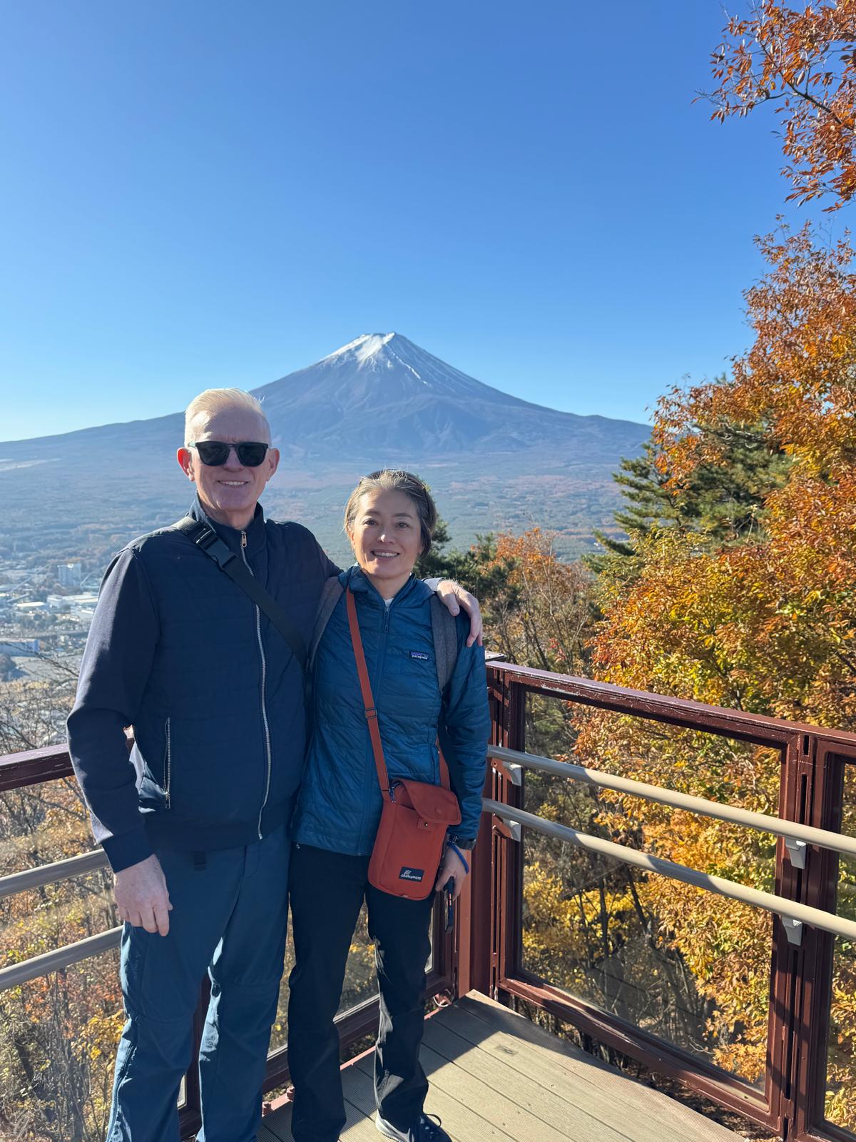 Keiko and Mark on a deck overlooking Mount Fuji
